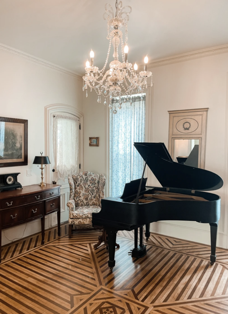 A grand piano sits in a beautifully decorated room of the Cargill-Pettibone Mansion.